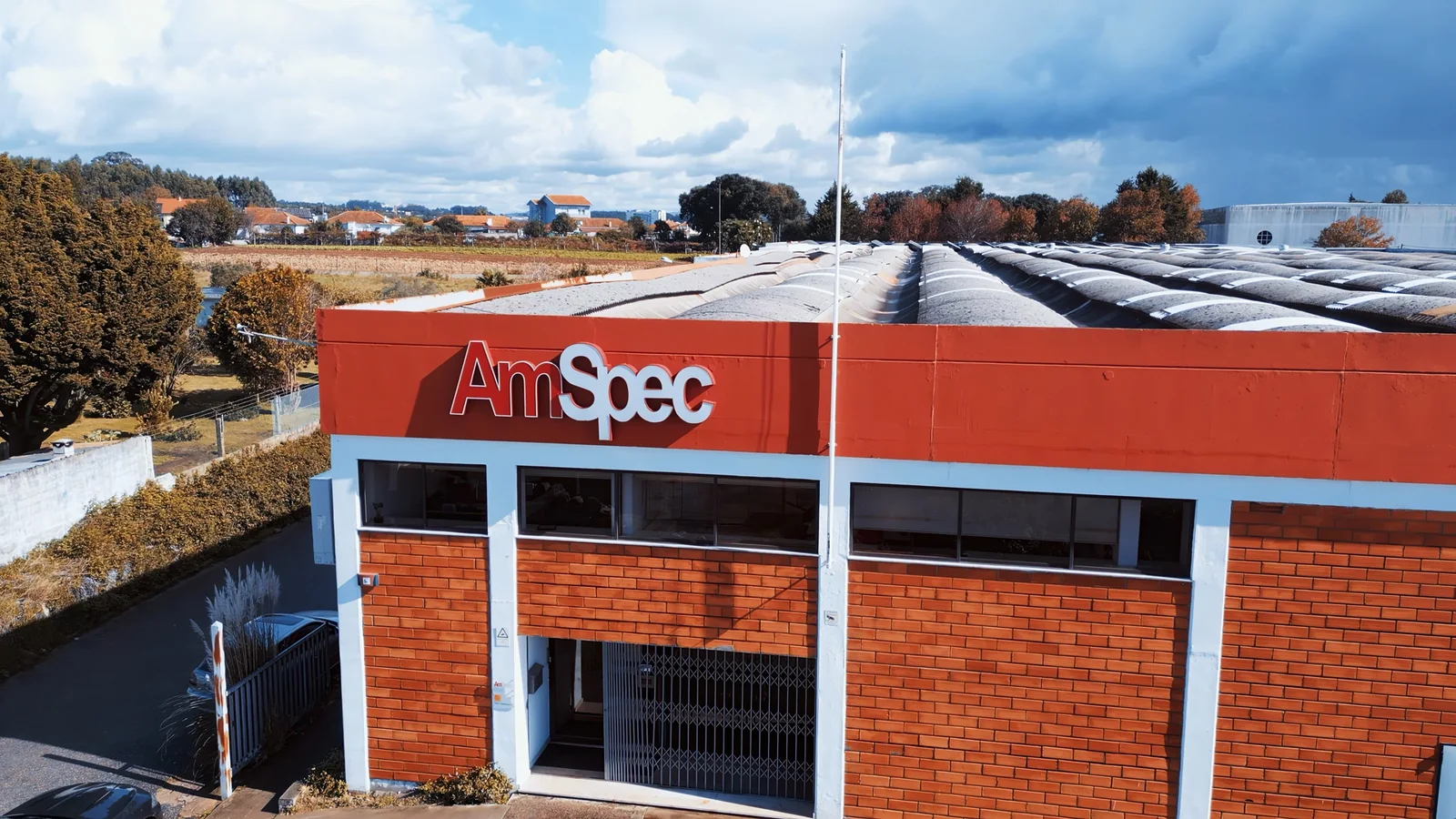 Vista aérea das instalações da AmSpec, com o logótipo na fachada